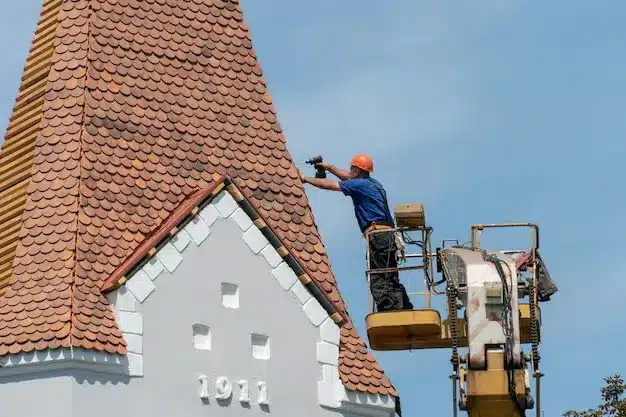 repair-reconstruction-old-roof-red-tiles-centennial-building-worker-this-crane-basket-works-at-height-dangerous-conditions-roof-repair-sunny-day
